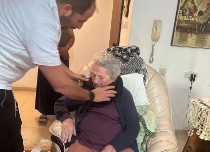 Distribution of warming winter accessories to a 104-year-old woman